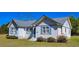 Charming white home featuring a gray roof and blue shutters, set on a well-maintained lawn at 8524 Cane Branch Rd, Ruffin, SC 29475