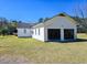 Two-car detached garage with open doors and clear space, showcasing potential for storage or workspace at 8524 Cane Branch Rd, Ruffin, SC 29475