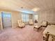 Cozy living room features classic furniture, complemented by soft carpet and a light fixture at 8524 Cane Branch Rd, Ruffin, SC 29475