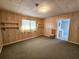 Inviting living room featuring a window, wood paneling, and shelving at 8524 Cane Branch Rd, Ruffin, SC 29475