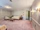 Cozy living room featuring a plush pink carpet, classic furnishings, and decorative wallpaper at 8524 Cane Branch Rd, Ruffin, SC 29475