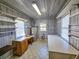 Utility room with water heater, utility sink, window, and cabinets at 8524 Cane Branch Rd, Ruffin, SC 29475
