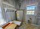 Utility room with water heater, shelves, and a window at 8524 Cane Branch Rd, Ruffin, SC 29475