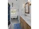 Elegant bathroom with a freestanding tub, stylish vanity, patterned tile and blue accents at 10044 Randall Rd, McClellanville, SC 29458