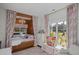 Charming bedroom with a built-in bed alcove, large window, and playful decor at 10044 Randall Rd, McClellanville, SC 29458