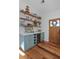 Butler pantry features custom blue cabinets, open shelving, marble countertops, and a wine fridge at 10044 Randall Rd, McClellanville, SC 29458