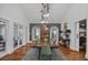 Dining room featuring a long wooden table, patterned wallpaper accent wall, and natural light at 10044 Randall Rd, McClellanville, SC 29458