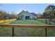 The beautiful light-green exterior of a single story house surrounded by a fenced in yard at 10044 Randall Rd, McClellanville, SC 29458