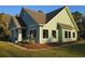 Charming exterior features manicured landscaping, shake siding, and a welcoming front porch with columns at 10044 Randall Rd, McClellanville, SC 29458
