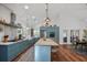 Spacious kitchen with blue cabinets, stainless steel appliances, and a large island with seating at 10044 Randall Rd, McClellanville, SC 29458