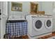 Unique laundry room with a vintage style tub sink, a stacked washer and dryer and wood accents at 10044 Randall Rd, McClellanville, SC 29458