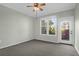 Bright and airy bedroom with neutral tones, a ceiling fan, and access to the outdoor balcony at 1012 Rosewood Ln, Mount Pleasant, SC 29464