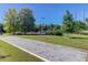 A well-maintained bocce ball court is surrounded by green lawns and mature trees at 1012 Rosewood Ln, Mount Pleasant, SC 29464