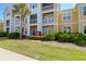 Low angle view of a condo building exterior with palm tree at 1012 Rosewood Ln, Mount Pleasant, SC 29464