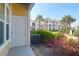 A ground-level exterior showing the unit door and common area landscaping at 1012 Rosewood Ln, Mount Pleasant, SC 29464