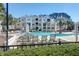 A picturesque pool area with chairs and sunshades alongside the condo building at 1012 Rosewood Ln, Mount Pleasant, SC 29464