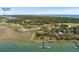 Scenic aerial view of a golf course community with waterfront homes and lush greenery at 108 Salthouse Ln, Kiawah Island, SC 29455