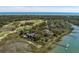 An aerial view showcases the waterfront property with a golf course nearby offering stunning ocean views at 108 Salthouse Ln, Kiawah Island, SC 29455