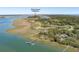 Expansive aerial view showcasing the beautiful coastal landscape, including the river course clubhouse at 108 Salthouse Ln, Kiawah Island, SC 29455