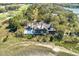 Beautiful aerial view of the home nestled amongst verdant trees and next to a lush golf course at 108 Salthouse Ln, Kiawah Island, SC 29455