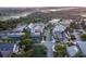 This is an aerial view of a charming shopping district with stores, sidewalks, mature trees, and ample parking at 108 Salthouse Ln, Kiawah Island, SC 29455