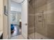 Modern bathroom with a glass-enclosed shower and serene decor, adjacent to a cozy bedroom at 108 Salthouse Ln, Kiawah Island, SC 29455