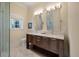 Bright bathroom featuring double vanity, granite counters, and glass shower door at 108 Salthouse Ln, Kiawah Island, SC 29455