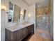 Stylish bathroom featuring dual vanity with marble countertop and walk-in shower at 108 Salthouse Ln, Kiawah Island, SC 29455
