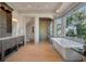 Luxurious bathroom featuring a soaking tub with a view, a spacious shower, and elegant vanity with granite counters at 108 Salthouse Ln, Kiawah Island, SC 29455