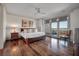 Spacious bedroom features hardwood floors, a ceiling fan, and sliding glass doors opening to a waterfront view at 108 Salthouse Ln, Kiawah Island, SC 29455