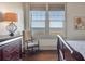 Bright bedroom features hardwood floors, large windows with waterfront views, and nautical decor at 108 Salthouse Ln, Kiawah Island, SC 29455