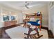 bedroom with wooden bunk beds, hardwood floors, and natural light from large windows at 108 Salthouse Ln, Kiawah Island, SC 29455