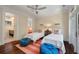 Charming bedroom with twin beds, colorful accents, and an inviting atmosphere with a view to the bathroom at 108 Salthouse Ln, Kiawah Island, SC 29455