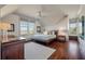 Comfortable bedroom featuring a ceiling fan, hardwood floors, and views of the marsh at 108 Salthouse Ln, Kiawah Island, SC 29455