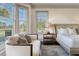 Inviting bedroom with golf course views, comfortable seating area, and elegant furnishings at 108 Salthouse Ln, Kiawah Island, SC 29455