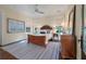 Bright bedroom with hardwood floors, area rug, ceiling fan, and natural light from large windows at 108 Salthouse Ln, Kiawah Island, SC 29455