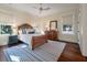 Bright bedroom with hardwood floors, area rug, ceiling fan, and natural light from large windows at 108 Salthouse Ln, Kiawah Island, SC 29455
