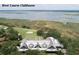 Scenic aerial shot featuring a golf clubhouse near the water with beautiful green vegetation at 108 Salthouse Ln, Kiawah Island, SC 29455