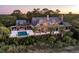 Luxurious waterfront home with a pool, outdoor dining, and stunning sunset views at 108 Salthouse Ln, Kiawah Island, SC 29455