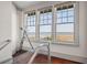 Bright hallway with modern glass railing and scenic water views from large picture windows at 108 Salthouse Ln, Kiawah Island, SC 29455