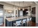 Open kitchen with dark cabinets, a large island with seating, stainless steel appliances and great lighting at 108 Salthouse Ln, Kiawah Island, SC 29455
