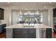 Open kitchen with stainless steel appliances, dark cabinets, a large island and views to the outdoors at 108 Salthouse Ln, Kiawah Island, SC 29455