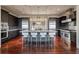 Modern kitchen features a large island, stainless steel appliances, dark cabinetry and hardwood floors at 108 Salthouse Ln, Kiawah Island, SC 29455