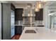 Modern kitchen design with stainless steel appliances, dark cabinetry, and a large island sink at 108 Salthouse Ln, Kiawah Island, SC 29455