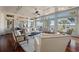 Bright, spacious living room with large windows, beautiful hardwood floors, and comfortable seating at 108 Salthouse Ln, Kiawah Island, SC 29455