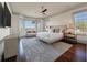 Serene main bedroom features a cozy sofa, bay windows with scenic views, and a plush king-sized bed at 108 Salthouse Ln, Kiawah Island, SC 29455