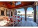 Covered patio with outdoor dining set and a view of the pool and waterfront at 108 Salthouse Ln, Kiawah Island, SC 29455