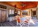 A covered outdoor kitchen features stainless steel appliances, granite countertops, and seating for outdoor dining at 108 Salthouse Ln, Kiawah Island, SC 29455