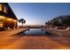 Stunning infinity pool overlooking the water, complemented by a spacious deck and lounge chairs at twilight at 108 Salthouse Ln, Kiawah Island, SC 29455