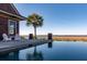 Beautiful infinity pool with lounge area, showcasing stunning waterfront views and a modern design at 108 Salthouse Ln, Kiawah Island, SC 29455